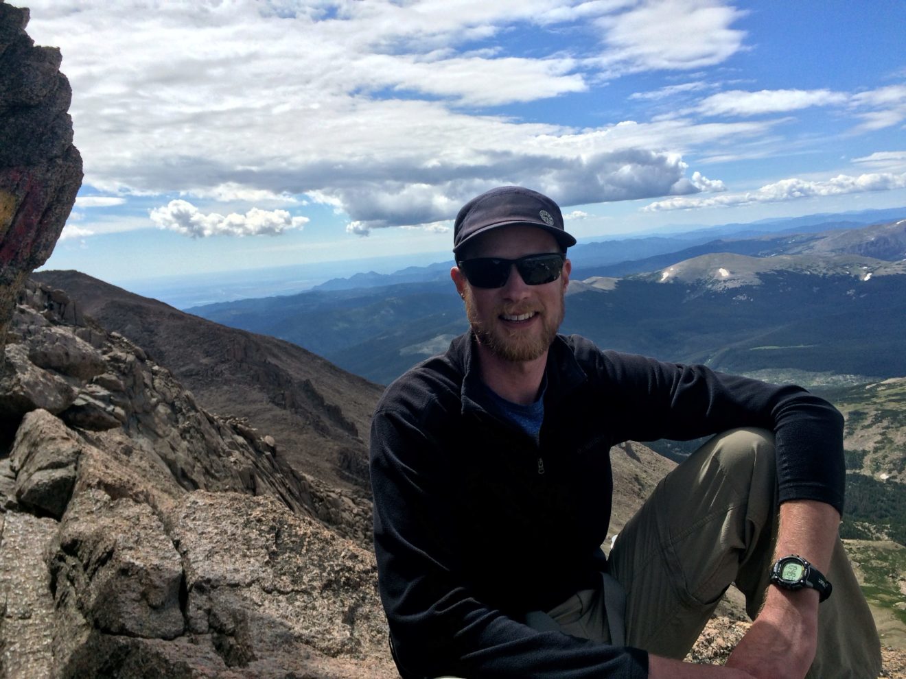 Circuit Media's lead designer, Joe Horton, poses in front of a scenic mountain view in Rocky Mountain National Park.