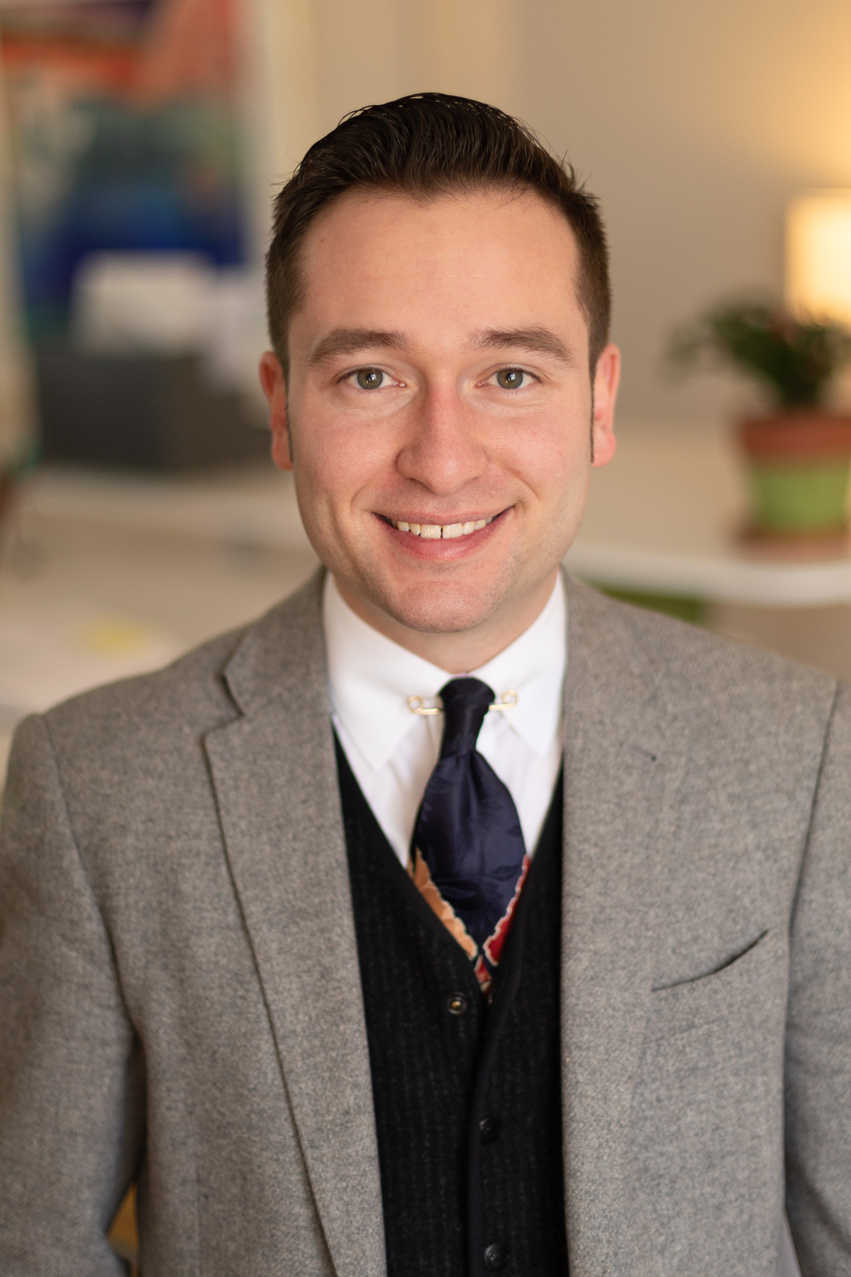 A male professional editor and writer at Circuit Media, smiling and wearing a suit jacket