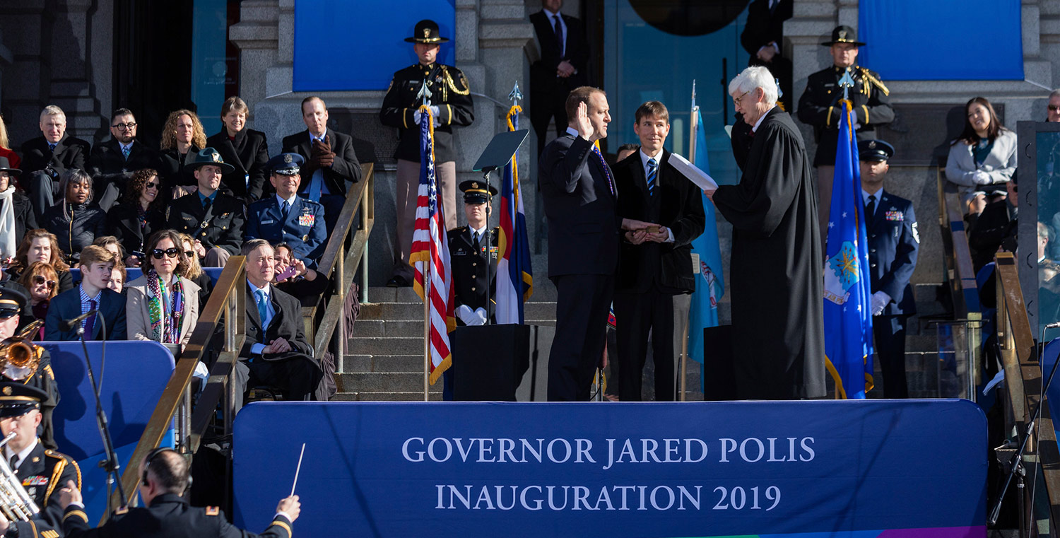 Governor Jared Polis being sworn into office in front of the Denver capitol 