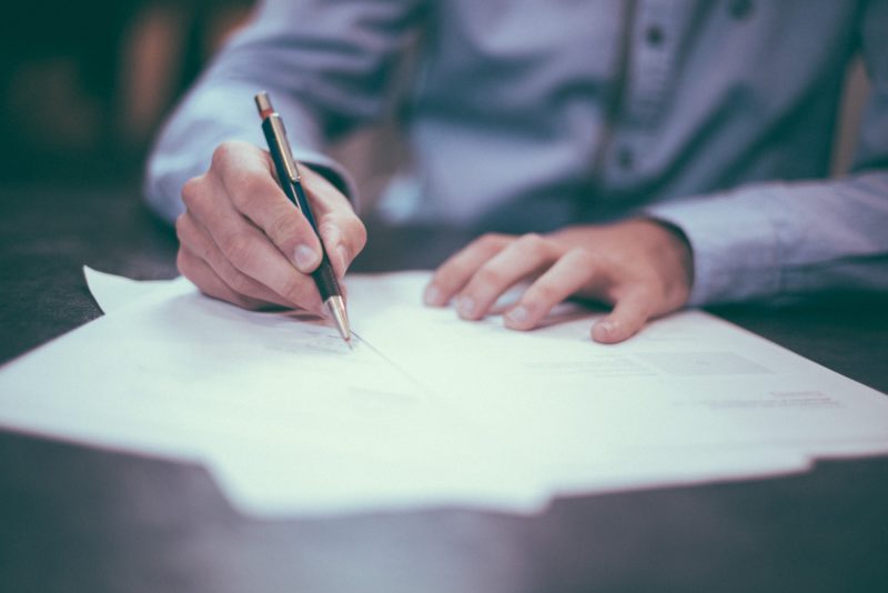 a man from the chest down signing contracts a man from the chest down signing contracts